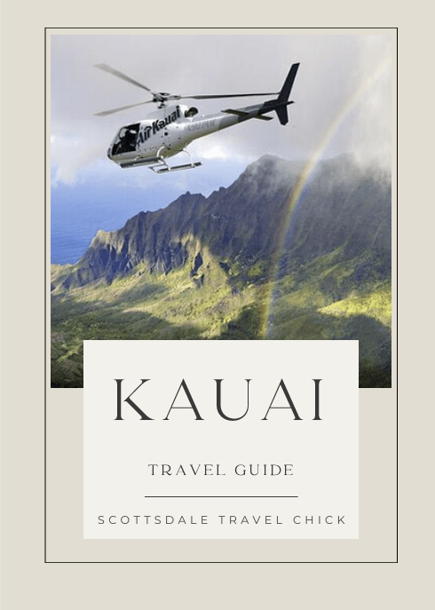 Helicopter flying over Kauai mountains with rainbow
