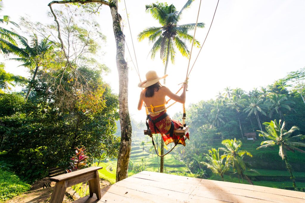 Woman swinging over rice terraces