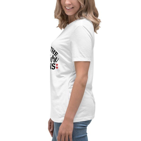 Woman wearing a white printed t-shirt, side view.