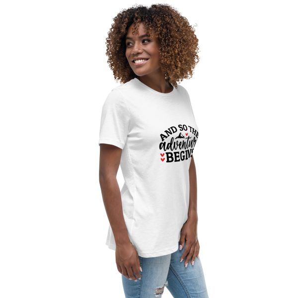 Woman wearing 'Adventure Begins' t-shirt, smiling.