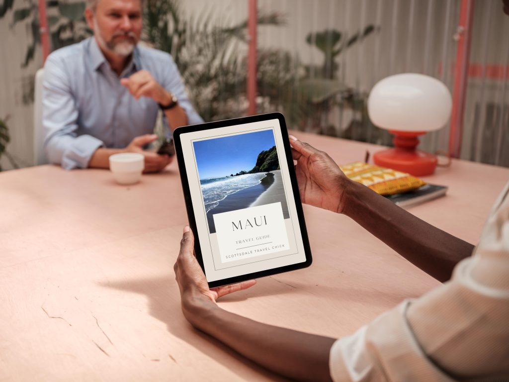 Best of Maui: Beaches, Hikes & Hidden Gems Person viewing Maui travel guide on tablet.